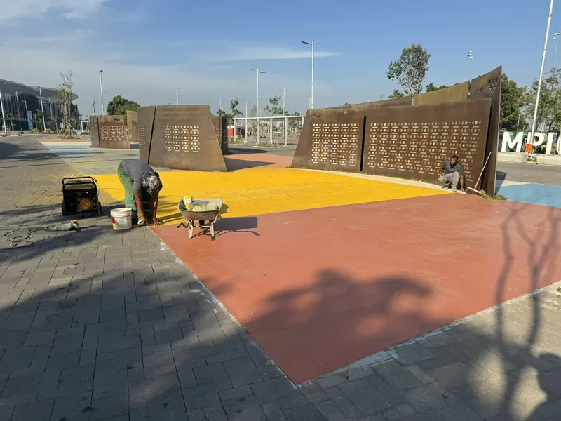 Aplicação de piso amarelo e laranja junto às placas do Parque Olímpico