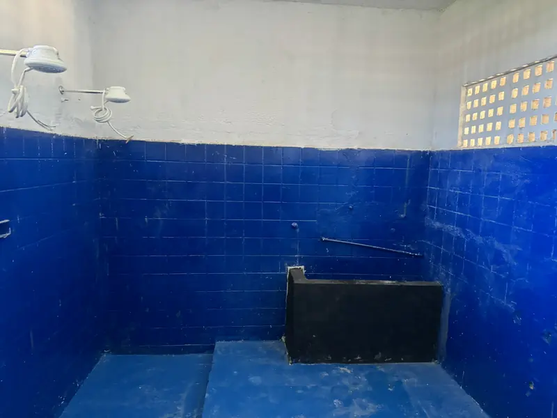 Banco de concreto revestido no vestiário de azulejo azul